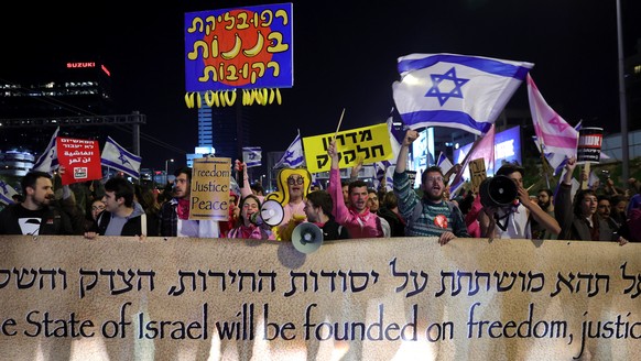 epa10475917 Israeli protesters block the Ayalon highway during an anti-government protest in Tel Aviv, Israel, February 18, 2023. People protested against the government's legal system...