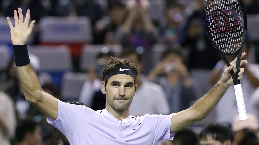 Roger Federer of Switzerland celebrates after winning his men&#039;s singles match against Alexandr Dolgopolov of Ukraine in the Shanghai Masters tennis tournament at Qizhong Forest Sports City Tennis ...