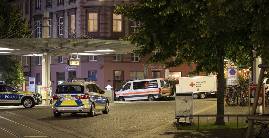 Emergency vehicles stand near the scene of an incident on Barbarossaplatz in the city centre of Wuerzburg, Germany, Friday, June 25, 2021. Authorities say a man armed with a long knife killed several  ...