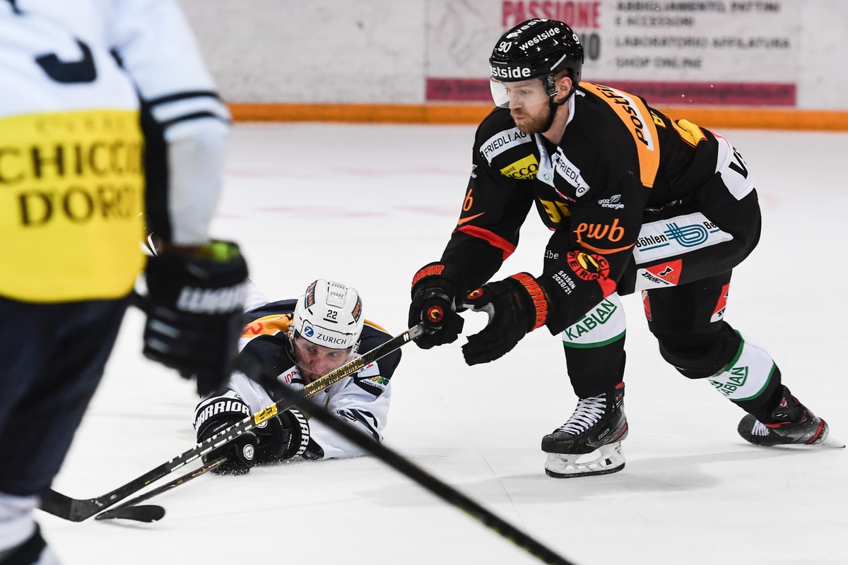 Ambri's player Diego Kostner, left, fight for the puck with Bern's player Ted Brithen, right, during the friendly match of National League A (NLA) Swiss Championship 2020/21 between HC Ambri ...