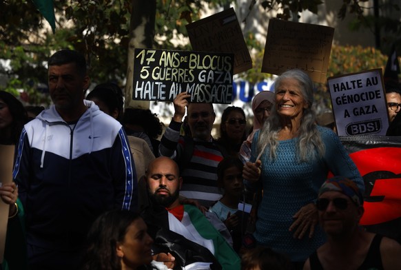 epa10930814 People with Palestine flags shout slogans as they attend a demonstration in support of the Palestinian people, in Montpellier, France, 21 October 2023. Thousands of Israelis and Palestinia ...