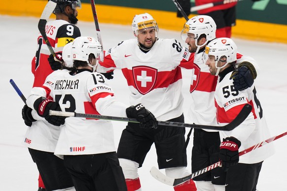 Switzerland&#039;s Roman Josi, 2nd right, celebrates with teammates after scoring his sides first goal during the preliminary round match between Austria and Switzerland at the Ice Hockey World Champi ...