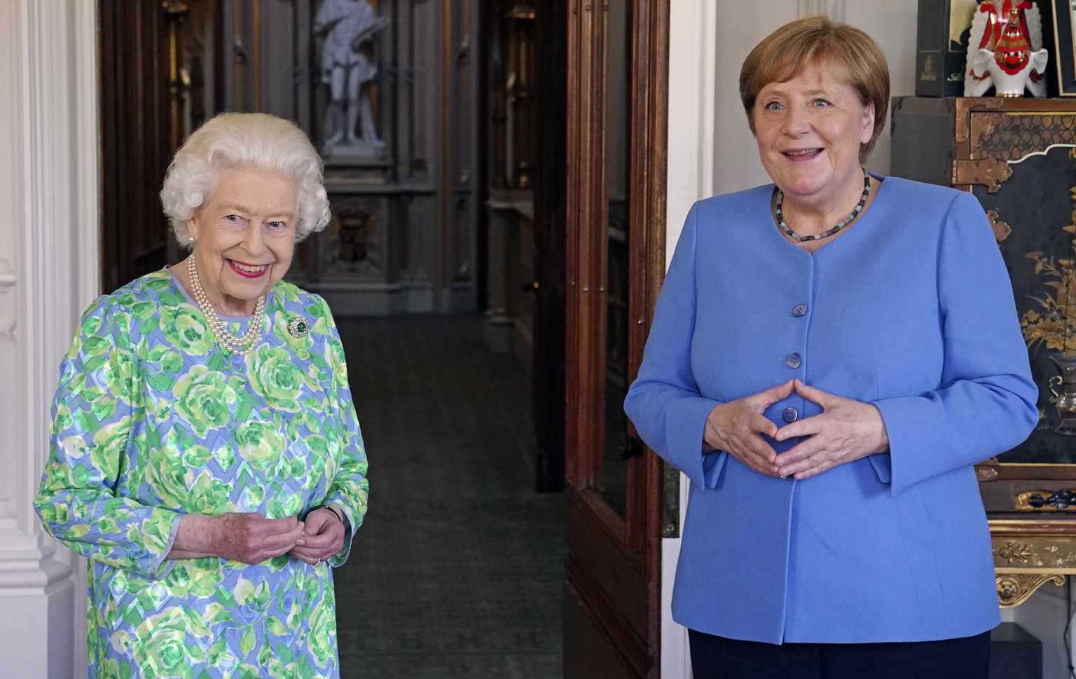 Britain&#039;s Queen Elizabeth receives the Chancellor of Germany Angela Merkel during an audience at Windsor Castle in Berkshire, England, Friday, July 2, 2021. (Steve Parsons/Pool Photo via AP)