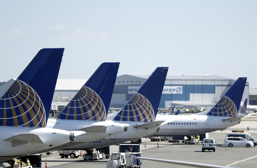 FILE - In this July 18, 2018, file photo, United Airlines commercial jets sit at a gate at Terminal C of Newark Liberty International Airport in Newark, N.J. United Airlines is pulling the Boeing 737  ...