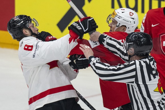 Switzerland&#039;s Calvin Thuerkauf, right, in action against Canada&#039;s Michael Bunting during the Ice Hockey World Championship group A preliminary round match between Switzerland and Canada in P ...