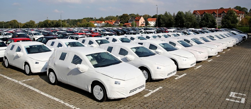 epa04965488 New VW Golf cars packed for transport are parked on the site of a logistics company in Goessnitz, Germany, 05 October 2015. The company is taking over the transportation for the nearby VW  ...