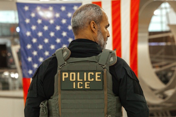 epa12844849 A US Immigration and Customs Enforcement (ICE) agent patrols the John F. Kennedy International Airport, amid congestion caused by the Department of Homeland Security (DHS) shutdown, in the ...