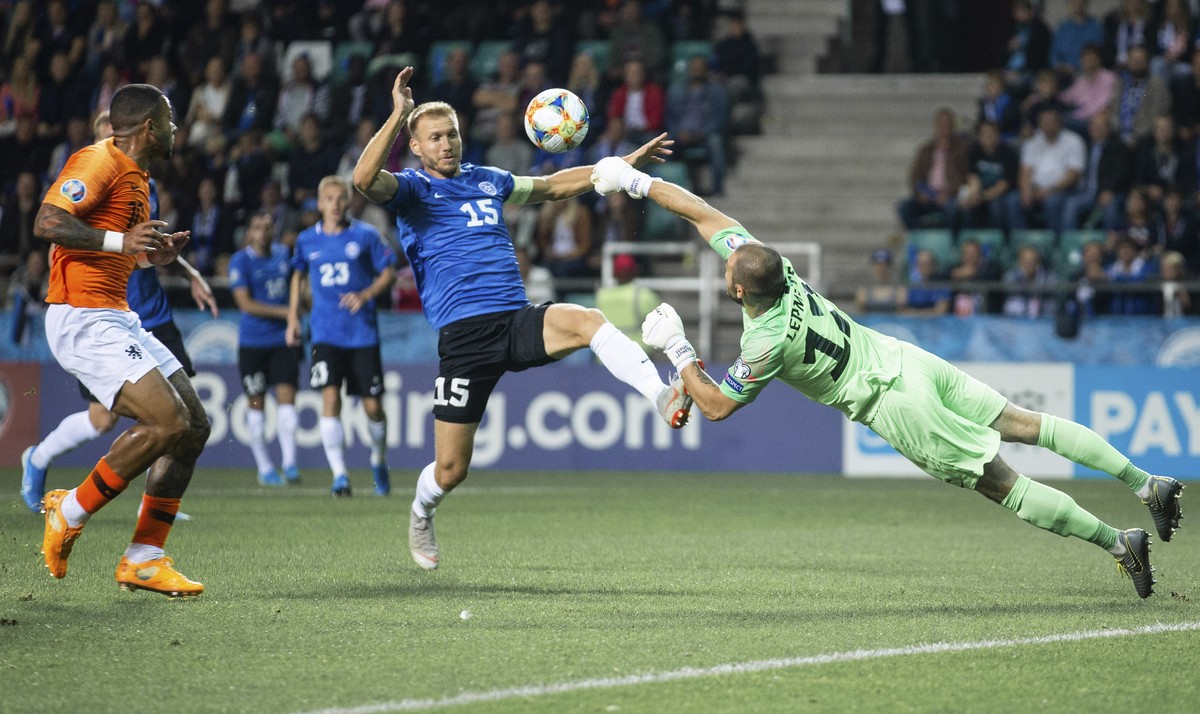 Estonia's goalkeeper Sergei Lepmets, right, blocks the ball during the Euro 2020 group C qualifying soccer match between Estonia and Netherlands at the A. Le Coq Arena in Tallinn, Estonia, Monday ...