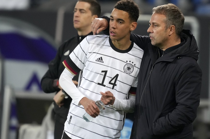 Germany&#039;s coach Hansi Flick, right, gives instructions to Germany&#039;s Jamal Musiala during the international friendly soccer match between Germany and Israel in Sinsheim, Germany, Saturday, Ma ...
