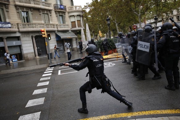 Spanish riot police shoots rubber bullet straight to people trying to reach a voting site at a school assigned to be a polling station by the Catalan government in Barcelona, Spain, Sunday, 1 Oct. 201 ...