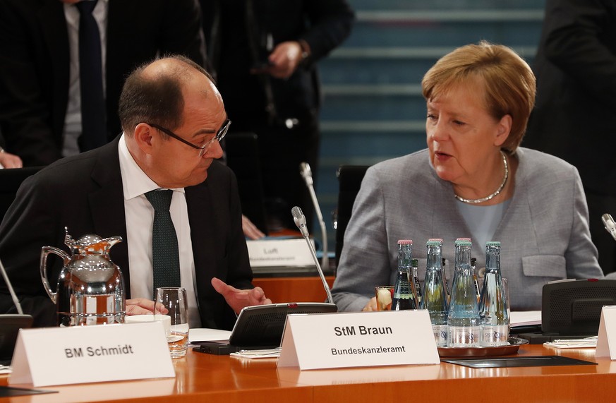 epa06355048 German Minister of Agriculture, Christian Schmidt (L) talks with German Chancellor Angela Merkel, at the beginning of a meeting with representatives of communities affected by pollution re ...
