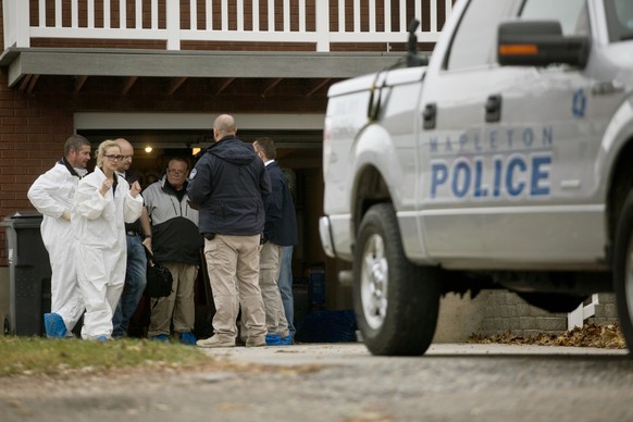 Police and officials respond to the scene where a family of four were found shot to death in Mapleton, Utah, Friday, Nov. 10, 2017. A Utah family of four and their dog have been found dead with gunsho ...