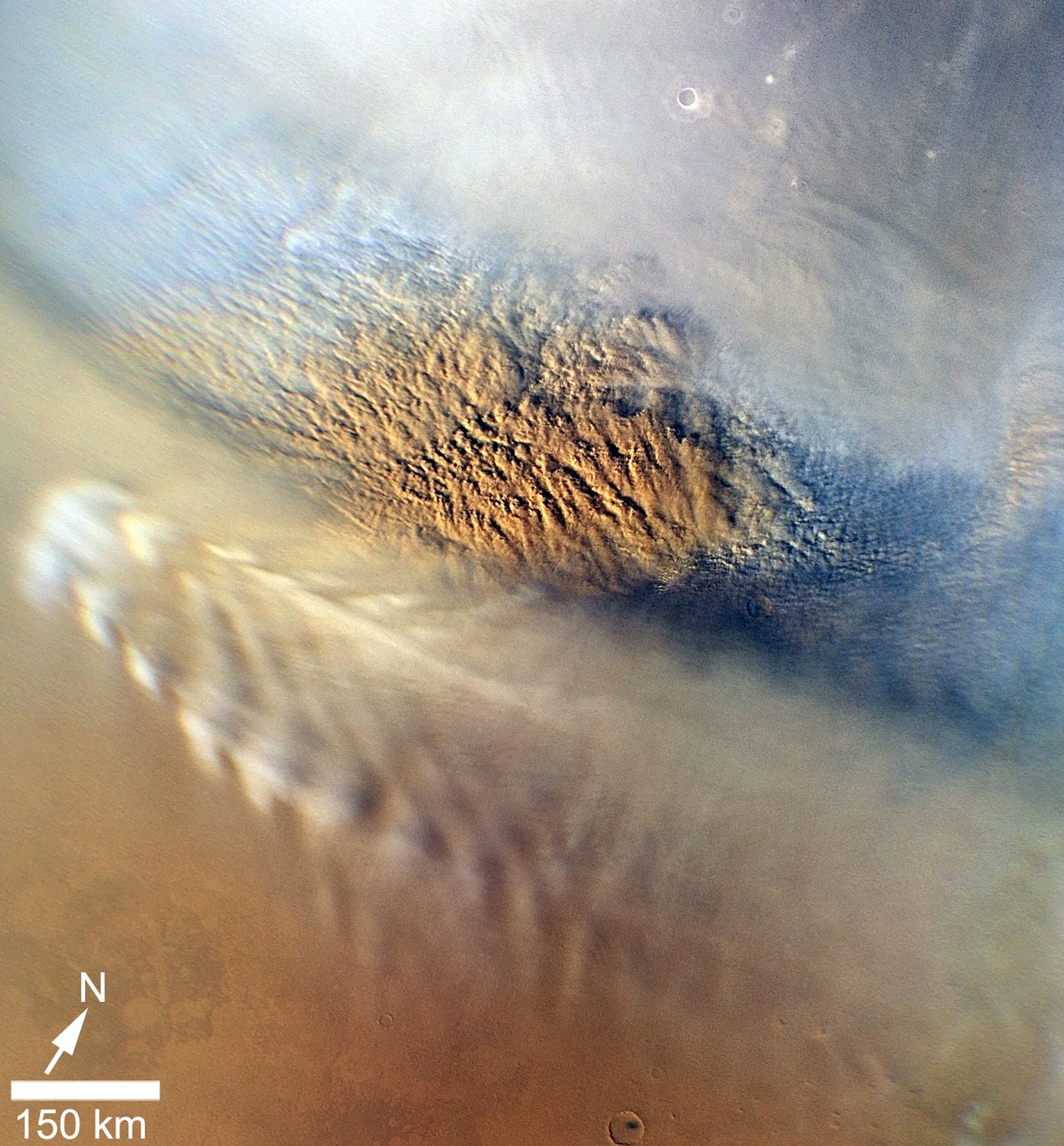 Bei den weisslichen Mustern am unteren Rand dieser Aufnahme des&nbsp;Mars Reconnaissance Orbiters vom November 2007 handelt es sich um Wolken aus Wassereis. Weiter oben hingegen ist ein Sandsturm erkennbar, der allerdings weniger als 24 Stunden dauerte. Am oberen Rand ist das Eis des Mars-Nordpols zu erkennen.&nbsp; &nbsp;&nbsp;