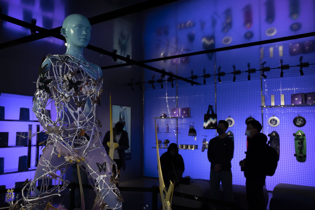 Visitors gather near a statue at a concept shop for Chinese electric car maker Jidu in Beijing, Tuesday, Feb. 14, 2023. Chinese tech company Baidu's electric car firm Jidu on Tuesday unveiled a & ...
