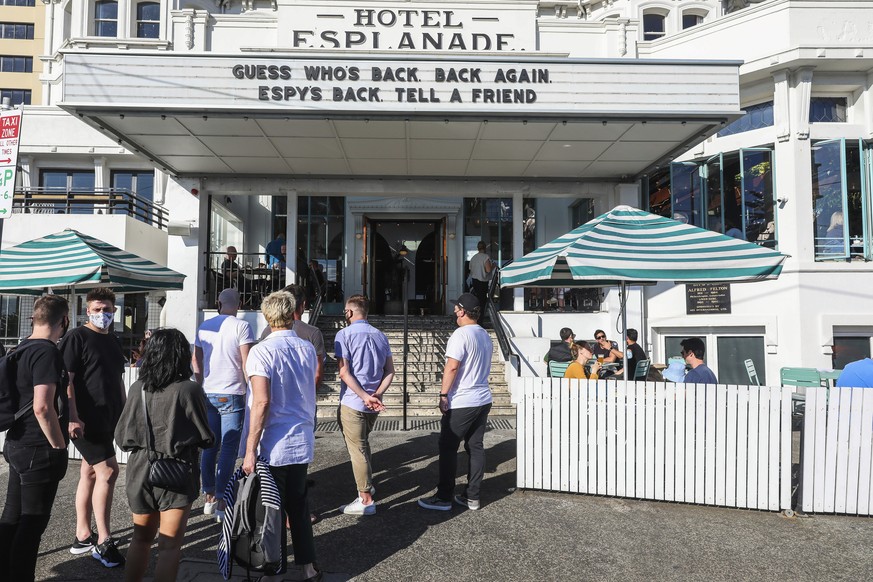 People line up outside a popular pub and restaurant in St Kilda in Melbourne, Australia, Wednesday, Oct. 28, 2020. Melbourne, Australia's former coronavirus hot spot, emerged from a lockdown at m ...