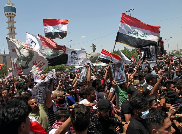 Anti-government protesters try to force their way into the Green Zone area, which houses the seat of the country&#039;s government and foreign embassies, during protests in Baghdad, Iraq, Tuesday, May ...