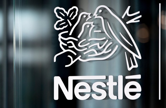 FILE - In this Thursday, Feb. 14, 2019, file photo, Nestle's logo is displayed on a window, during the 2018 full-year results press conference of the food and drinks giant Nestle, in Vevey. (Laur ...