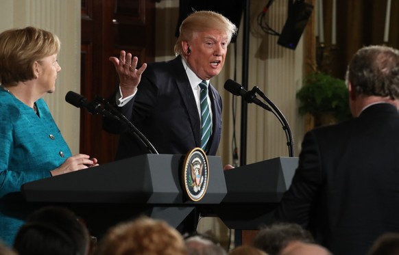 President Donald Trump, joined by German Chancellor Angela Merkel, left, speaks during a joint news conference in the East Room of the White House in Washington, Friday, March 17, 2017. (AP Photo/Andr ...