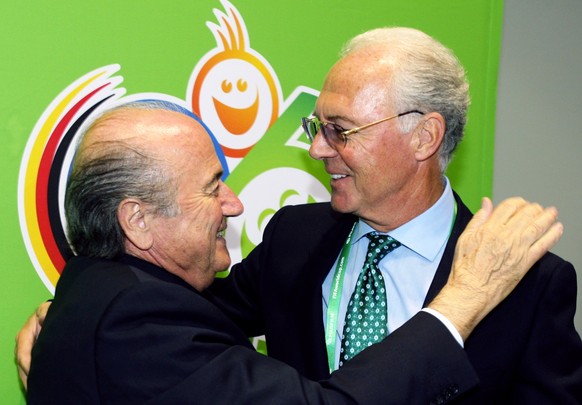 ARCHIV - 06.06.2006, Bayern, M�nchen: Der damalige FIFA-Pr�sident Joseph Blatter (l) und der damalige Pr�sident des Fu�ball-WM-Organisationskomitees 2006, Franz Beckenbauer, umarmen sich w�hrend der E ...