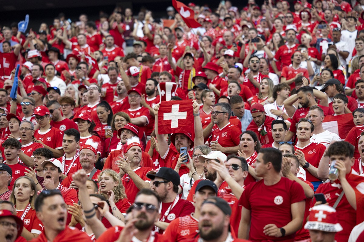 Swiss fans celebrate before a Group A match between Switzerland and Germany at the Euro 2024 soccer tournament in Frankfurt am Main, Germany, Sunday, June 23, 2024. (KEYSTONE/Peter Klaunzer)