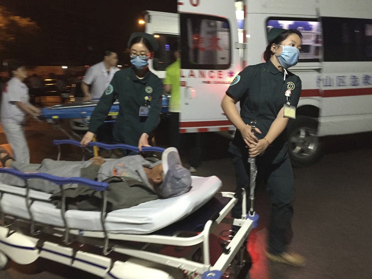 In this photo released by China's Xinhua News Agency, medical workers transport a person injured in an explosion outside a kindergarten into a hospital in Fengxian County in eastern China's  ...