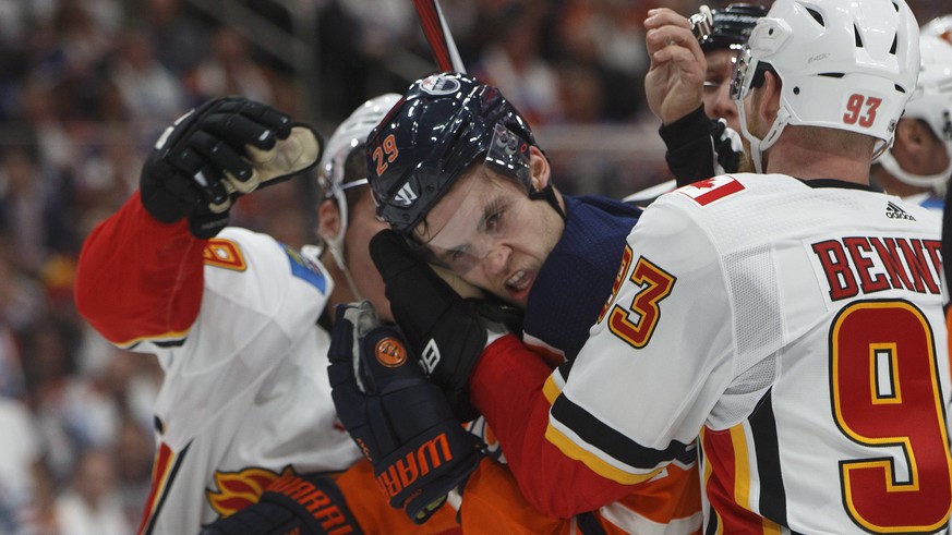 Calgary Flames&#039; Sam Bennett (93) grabs Edmonton Oilers&#039; Leon Draisaitl (29) during the second period of an NHL hockey game Wednesday, Oct. 4, 2017, in Edmonton, Alberta. (Jason Franson/The C ...