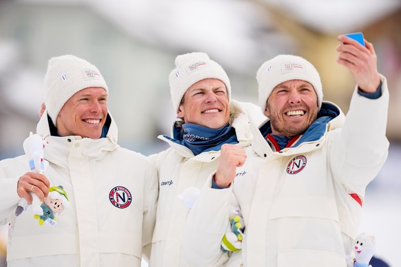 Silver medalist Martin Loewstroem Nyenget, gold medalist Johannes Hoesflot Klaebo and bronze medalist Emil Iversen, all three of Norway, pose on the podium of the cross country skiing men's 50km  ...