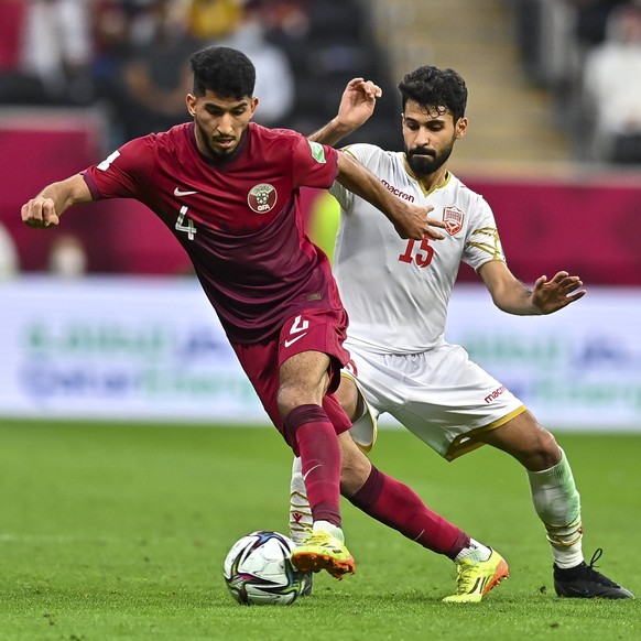 211201 -- AL KHOR, Dec. 1, 2021 -- Mohammed Waad L Of Qatar vies with Jasim Alshaikh of Bahrain during the FIFA Arab Cup 2021 Group A match between Qatar and Bahrain in Al Khor, Qatar, Nov. 30, 2021.  ...