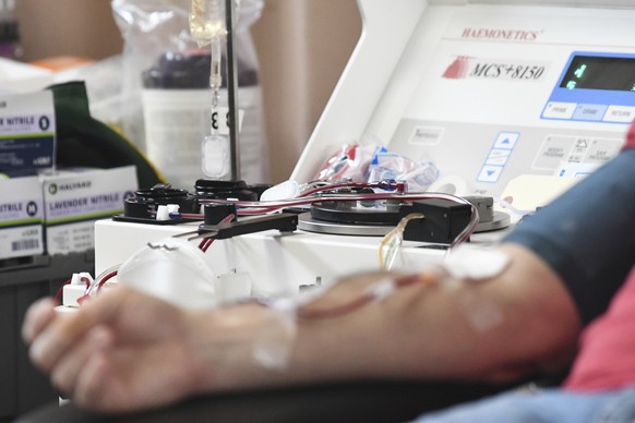 Blood flows into a centrifuge machine while Joe Ryan, of Pottsville, donates blood to the American Red Cross during a blood drive at Life Centre Foursquare Gospel in Pottsville, Pa. Thursday, Jan. 13, ...