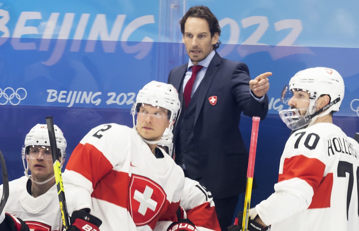 Patrick Fischer, head coach of Switzerland national ice hockey team, talks to his players, during the men's ice hockey preliminary round game between ROC (Russia) and Switzerland at the National  ...