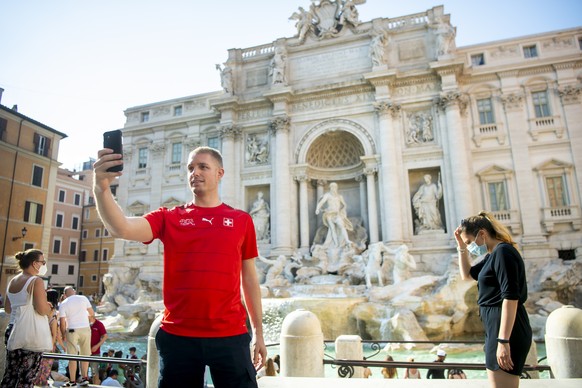 Stephane, takes a selfie with the Swiss football team jersey in front of the Trevi fountain, in Rome, Italy, Monday, June 14, 2021. The Swiss national soccer team will play Italy in Group A on Wednesd ...