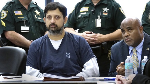 Nouman Raja sits with defense attorney Rick King during his sentencing Thursday in West Palm Beach April 25, 2019. Raja, a former Palm Beach Gardens police officer, was convicted on one count each of  ...