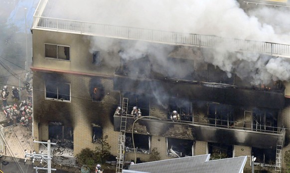 FILE - Firefighters respond to a building fire of Kyoto Animation in Kyoto, western Japan, on July 18, 2019. A murder trial began Tuesday, Sept. 5, 2023 for the 2019 deadly arson attack on the Kyoto a ...
