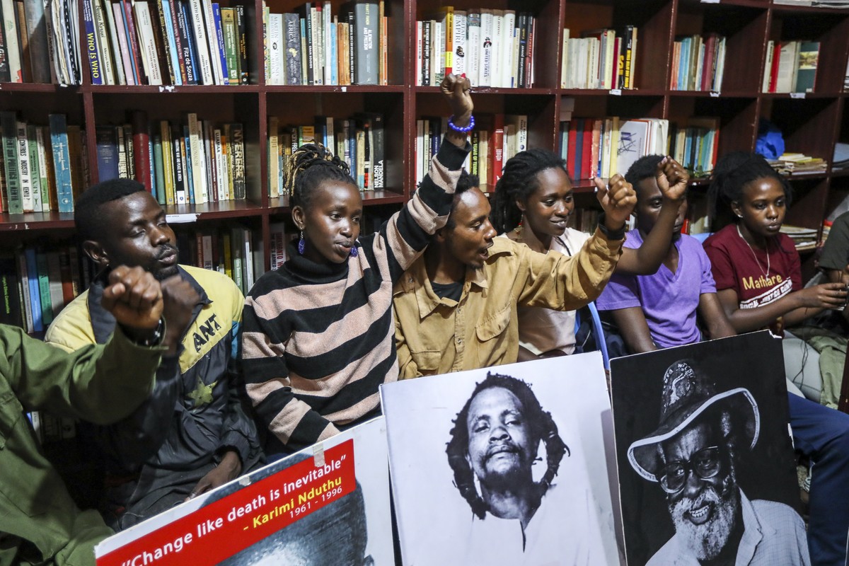 epa10951390 Kenyan social activists shout slogans in their undisclosed operation office after being dispersed outside by police as they put up a banner reading 'We want Kimathi?s Remains Now! ...