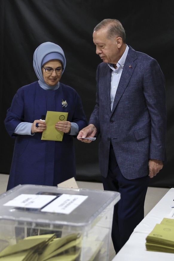 Turkish President Recep Tayyip Erdogan, and his wife Emine, left, prepare to cast their ballots at a polling station in Istanbul, Sunday, May 14, 2023. Turkey is voting Sunday in landmark parliamentar ...