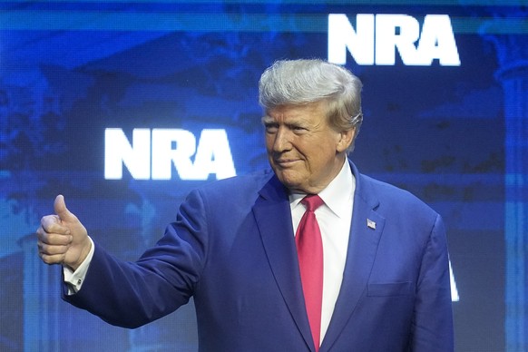 Former President Donald Trump responds to the crowd before speaking at the National Rifle Association Convention, Friday, April 14, 2023, in Indianapolis.  (AP Photo/Darron Cummings)