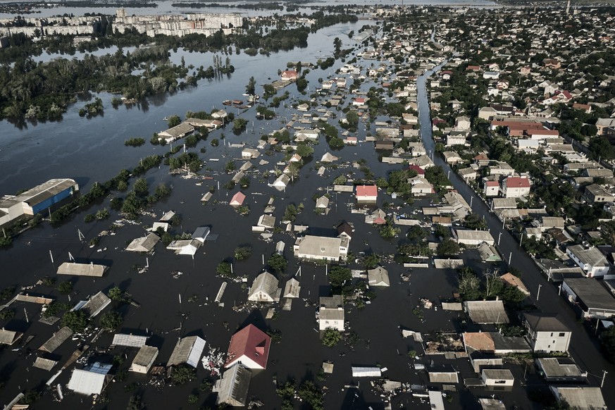 Streets are flooded in Kherson, Ukraine, Wednesday, June 7, 2023 after the Kakhovka dam was blown up. Residents of southern Ukraine, some who spent the night on rooftops, braced for a second day of sw ...