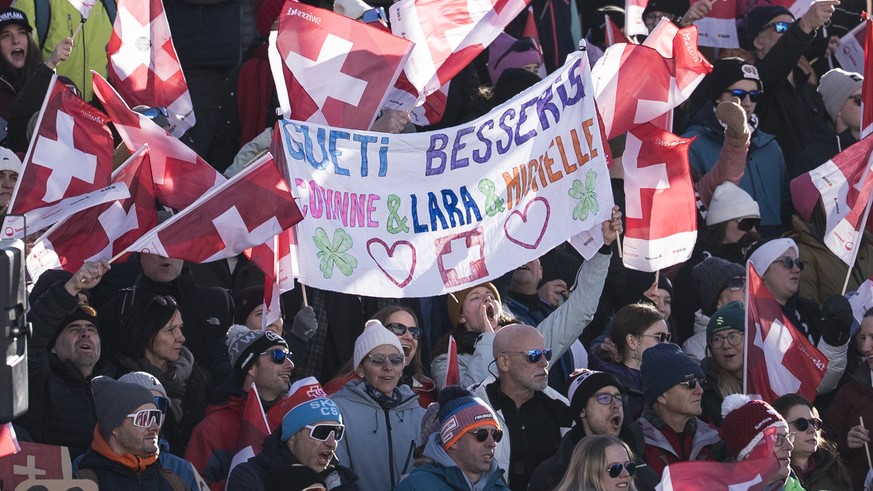 Fans hold up banners with recovery messages towards the injured swiss riders Corinne Suter, Lara Gut-Behrami and Michelle Gisin, during the women's Super-G race at the Alpine Skiing FIS Ski World ...