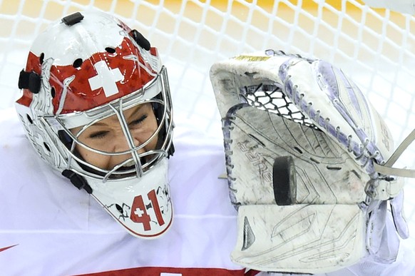 Switzerland&#039;s goalkeeper Florence Schelling stops the puck during the women&#039;s preliminary Group A game between Switzerland and Finland at the XXII Winter Olympics 2014 Sochi in Sochi, Russia ...