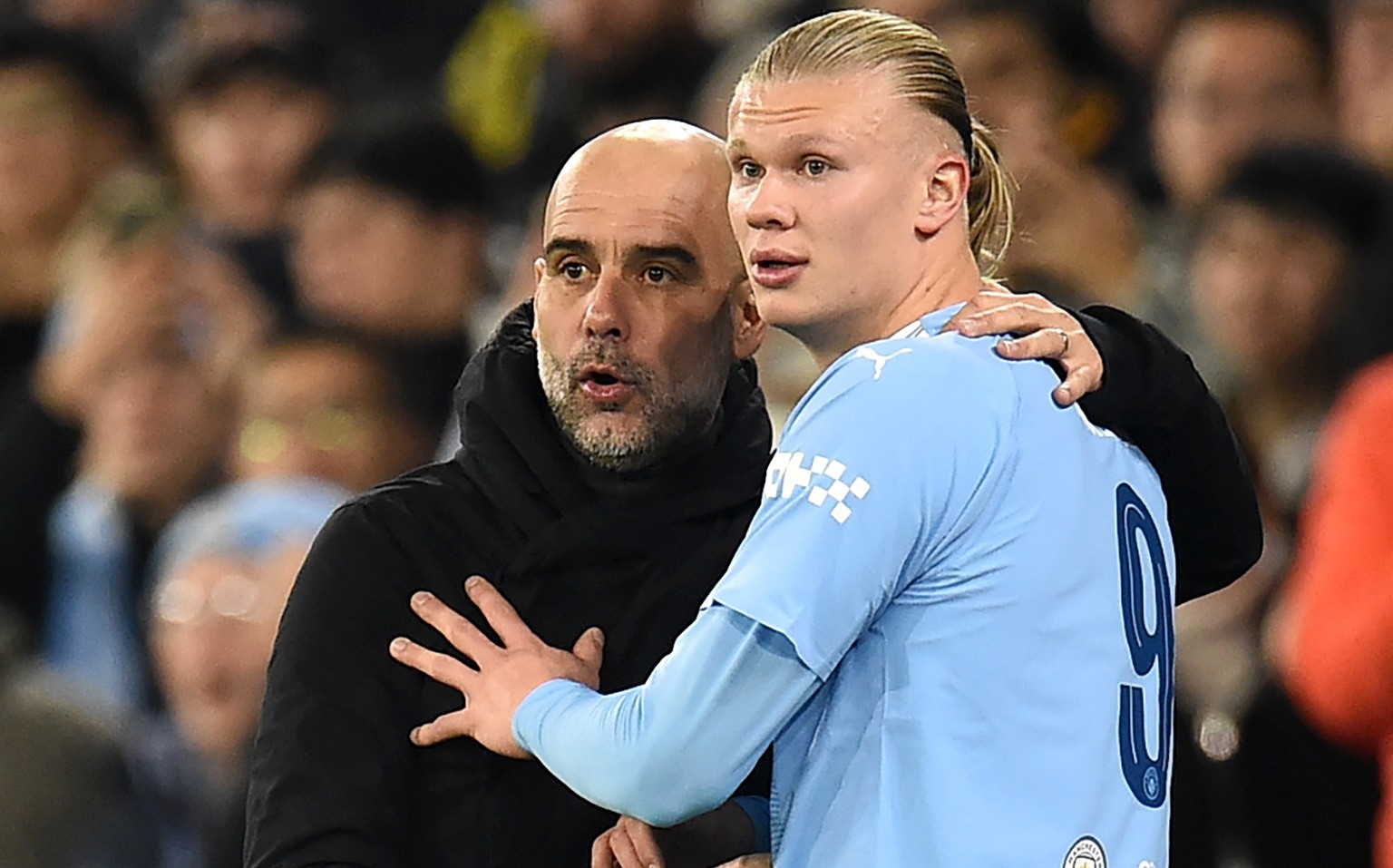 epa10963486 Manchester City manager Pep Guardiola (L) talks to striker Erling Haaland during the UEFA Champions League Group G match between Manchester City and Young Boys Bern, in Manchester, Britain ...