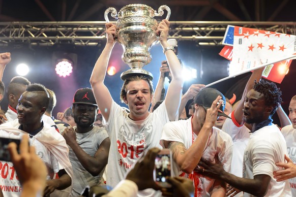 FC Sion players celebrates with the son of FC Sion president Christian Constantin, Barthelemy Constantin, center with the trophy, on stage in front of their fans after they won the Swiss Cup final soc ...