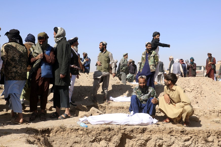Afghan men bury the victims after an earthquake in Zenda Jan district in Herat province, of western Afghanistan, Sunday, Oct. 8, 2023. Powerful earthquakes killed at least 2,000 people in western Afgh ...