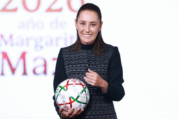 epa13078492 Mexican President Claudia Sheinbaum holds a soccer ball during a press conference at the National Palace in Mexico City, Mexico, 01 July 2026. Sheinbaum congratulated the Mexican national  ...