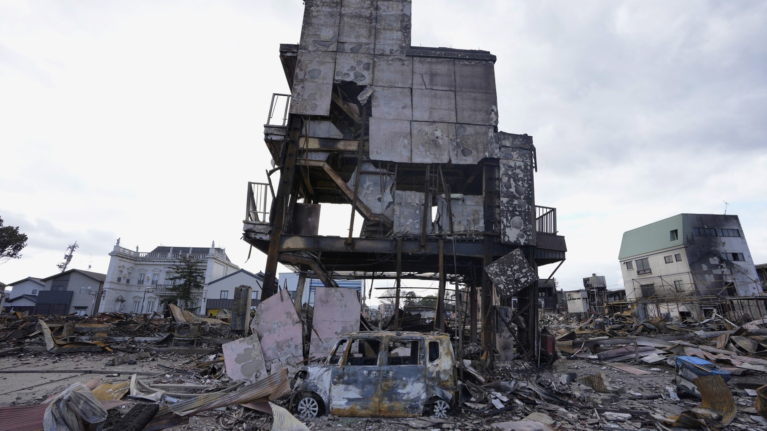A burned-out building and a vehicle are seen after a fire in Wajima in the Noto peninsula, facing the Sea of Japan, northwest of Tokyo, Friday, Jan. 5, 2024, following Monday&#039;s deadly earthquake. ...