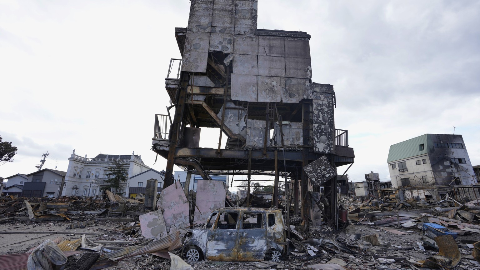 A burnt-out building and a vehicle are seen after a fire in Wajima on the Noto Peninsula, overlooking the Sea of ​​Japan, northwest of Tokyo, Friday, Jan. 5, 2024, following Monday's deadly earthquake.  ...