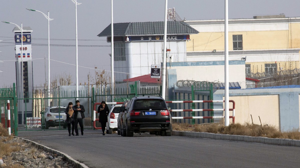 FILE - In this Dec. 3, 2018, file photo, people walk by a police station by the front gate of the Artux City Vocational Skills Education Training Service Center in Artux in western China's Xinjia ...