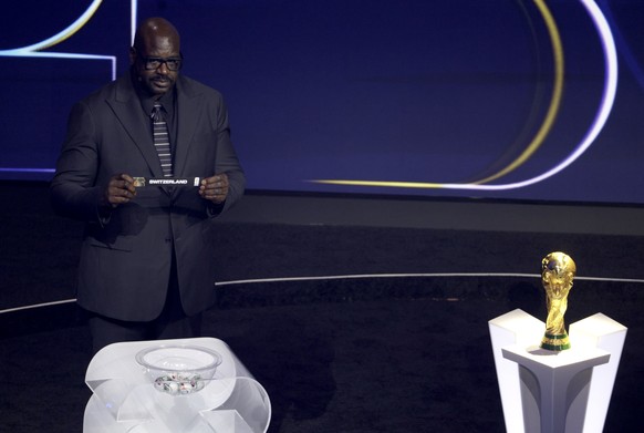 epa12572752 Draw assistant Shaquille O'Neal holds the ticket of Switzerland during the FIFA World Cup 2026 Final Draw at the Kennedy Center in Washington DC, USA, 05 December 2025. EPA/SHAWN THEW