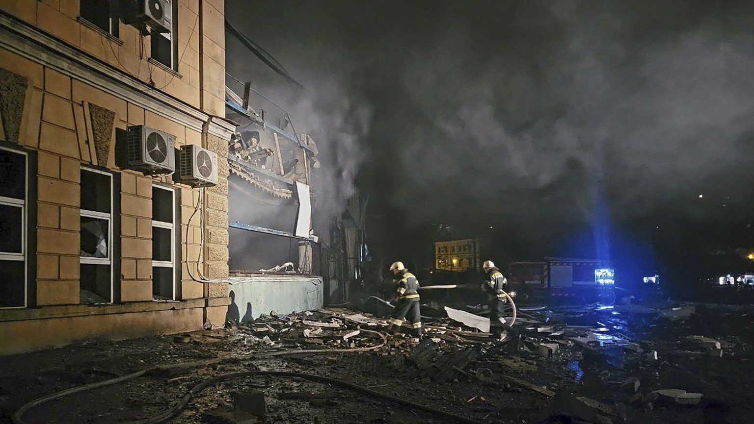 In this photo provided by Odesa City Administration, Ukrainian emergency workers examine the site of a Russian rocket attack in central Odesa, Ukraine, early hours on Monday, Nov. 6, 2023. (Odesa City ...