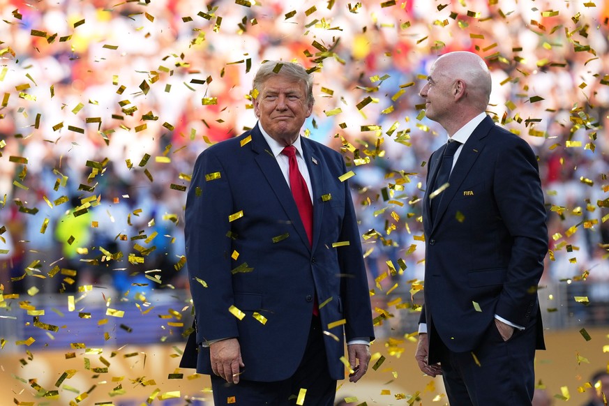 President Donald Trump, left, and FIFA President Gianni Infantino watch confetti fall at the conclusion of the World Cup championship final soccer match between Spain and Argentina in East Rutherford, ...
