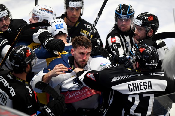 Lugano&#039;s player Alessio Bertaggia, Ambri&#039;s player Elias Bianchi, Ambri&#039;s player Tobias Fohrler and Lugano&#039;s player Alessandro Chiesa, from left, during a brawl, during the prelimin ...